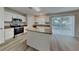 Modern kitchen features stainless appliances, granite counters and center island at 105 Evergreen Dr, Auburndale, FL 33823