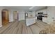 Open kitchen features center island, white cabinets, and stainless appliances at 105 Evergreen Dr, Auburndale, FL 33823