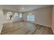 Bright living room featuring laminate flooring and archways to the kitchen at 105 Evergreen Dr, Auburndale, FL 33823