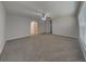 Spacious living room featuring carpet flooring, a ceiling fan, and an archway at 105 Evergreen Dr, Auburndale, FL 33823