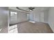 Spacious primary bedroom features a trey ceiling, neutral carpeting, two windows, and direct access to ensuite bathroom at 105 Evergreen Dr, Auburndale, FL 33823