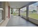 The outdoor screened porch features wide views of the lush, green backyard and a painted concrete floor at 105 Evergreen Dr, Auburndale, FL 33823