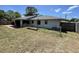 View of the backyard and exterior of the home with chain link fence at 11757 Se 71St Terrace Rd, Belleview, FL 34420