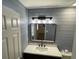 Updated bathroom with a modern vanity, stylish mirror, and soothing shiplap walls at 11757 Se 71St Terrace Rd, Belleview, FL 34420