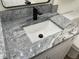 Close-up shot of bathroom granite vanity featuring a modern faucet and white sink at 11757 Se 71St Terrace Rd, Belleview, FL 34420