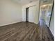 Well-lit bedroom showcasing wood flooring, closet space, and neutral walls at 11757 Se 71St Terrace Rd, Belleview, FL 34420