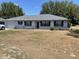 Charming single-story home featuring a well-maintained lawn and neutral exterior at 11757 Se 71St Terrace Rd, Belleview, FL 34420