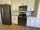 View of kitchen with stainless steel appliances, granite countertops, and white cabinetry at 11757 Se 71St Terrace Rd, Belleview, FL 34420