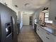Renovated kitchen featuring stainless steel appliances, granite countertops, and sleek white cabinetry at 11757 Se 71St Terrace Rd, Belleview, FL 34420