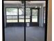 View of the carpeted lanai with screened windows and view of the fenced backyard at 11757 Se 71St Terrace Rd, Belleview, FL 34420