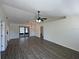 Spacious living room featuring vaulted ceiling and sliding glass doors to porch at 11757 Se 71St Terrace Rd, Belleview, FL 34420