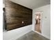Cozy living space with wood accent wall detail and a view to the kitchen at 11757 Se 71St Terrace Rd, Belleview, FL 34420
