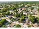 Wide aerial shot shows a residential neighborhood with tree-lined streets and various homes at 1960 Hamilton St, Bartow, FL 33830
