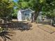 Backyard view of a single-story home with a chain-link fence and a large tree at 1960 Hamilton St, Bartow, FL 33830