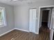 Bedroom featuring a ceiling fan, wood-look flooring, closet and view of the door to another room at 1960 Hamilton St, Bartow, FL 33830
