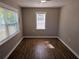 Bright bedroom with wood floors, large windows, and neutral wall paint at 1960 Hamilton St, Bartow, FL 33830