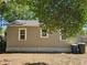 Home exterior with two windows, a blue trash can, and a yard waste bin at 1960 Hamilton St, Bartow, FL 33830