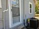 Home exterior with screen door, window, newer AC unit, and pipes at 1960 Hamilton St, Bartow, FL 33830