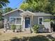 Cozy single-story home with a blue front door, neat landscaping, and a welcoming facade at 1960 Hamilton St, Bartow, FL 33830