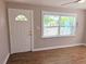 Living room featuring a front door, window views, and wood flooring at 1960 Hamilton St, Bartow, FL 33830