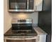 Range and overhead microwave in kitchen with white cabinets and granite countertops at 1960 Hamilton St, Bartow, FL 33830