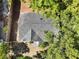 Aerial shot of roof with dark shingles surrounded by large trees on a sunny day at 1960 Hamilton St, Bartow, FL 33830