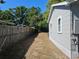 Side yard view of a single-story home, showing the exterior siding and a fenced boundary at 1960 Hamilton St, Bartow, FL 33830