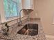 Close-up of a stainless steel sink with granite countertops and modern fixtures at 1960 Hamilton St, Bartow, FL 33830