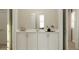 Bathroom with white cabinets, quartz countertop, and a modern mirror, providing a clean and bright aesthetic at 2934 Haze Rd, Clermont, FL 34714