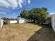Large, grassy backyard with white privacy fence and storage shed at 3210 Se 54Th Cir, Ocala, FL 34480