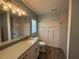 Bright bathroom with a modern sink, wood tile flooring, and decorative shower at 3210 Se 54Th Cir, Ocala, FL 34480