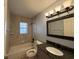 Well-lit bathroom featuring granite countertops, tile flooring, and a shower-tub combo at 3210 Se 54Th Cir, Ocala, FL 34480