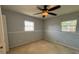 Simple bedroom with carpet, ceiling fan, and two windows at 3210 Se 54Th Cir, Ocala, FL 34480