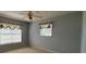 Bedroom with carpet, a ceiling fan, and two windows with curtains at 3210 Se 54Th Cir, Ocala, FL 34480