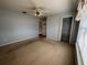 Spacious bedroom featuring ceiling fan, carpeted floors, and a closet for ample storage at 3210 Se 54Th Cir, Ocala, FL 34480