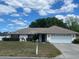 Charming one-story home with a well-maintained lawn and a two car garage at 3210 Se 54Th Cir, Ocala, FL 34480