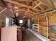 Interior view of the shed features plywood walls, exposed roof beams and rafters, and storage shelves at 3210 Se 54Th Cir, Ocala, FL 34480