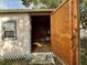 Storage shed featuring double doors, a window, shelves, and a bicycle at 3210 Se 54Th Cir, Ocala, FL 34480