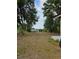 Large backyard with mature trees and space for recreation at 1710 Hamilton St, Bartow, FL 33830