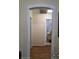 Hallway with hardwood floors leads to rooms with natural light streaming through the windows at 1710 Hamilton St, Bartow, FL 33830