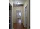 Hallway with hardwood floors leads to rooms with natural light streaming through the windows at 1710 Hamilton St, Bartow, FL 33830