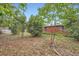 The backyard features a classic brick home surrounded by lush greenery and a mix of beautiful trees at 3026 Pinedale Ave, Lakeland, FL 33803