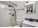 Bathroom featuring shower with shampoo niche, rainfall shower head, sleek hardware, & modern vanity at 3026 Pinedale Ave, Lakeland, FL 33803