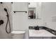 Bathroom featuring a toilet, shower head, sink with matte black finishes and tiled backsplash at 3026 Pinedale Ave, Lakeland, FL 33803