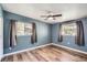 Bedroom with wood flooring, ceiling fan, and two windows bringing in natural light at 3026 Pinedale Ave, Lakeland, FL 33803