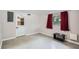 Bright bedroom with a door, a window with red curtains, and neutral colored walls at 3026 Pinedale Ave, Lakeland, FL 33803