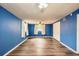 Open bedroom with wood-look floors, a ceiling fan, and ample natural light at 3026 Pinedale Ave, Lakeland, FL 33803