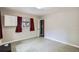 A simple bedroom offers ample light with a window, neutral walls, and light flooring at 3026 Pinedale Ave, Lakeland, FL 33803