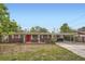 Charming single-story brick home featuring a vibrant red front door and covered carport at 3026 Pinedale Ave, Lakeland, FL 33803