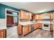 A wide shot of a traditional style kitchen with wood cabinets and modern appliances at 3026 Pinedale Ave, Lakeland, FL 33803